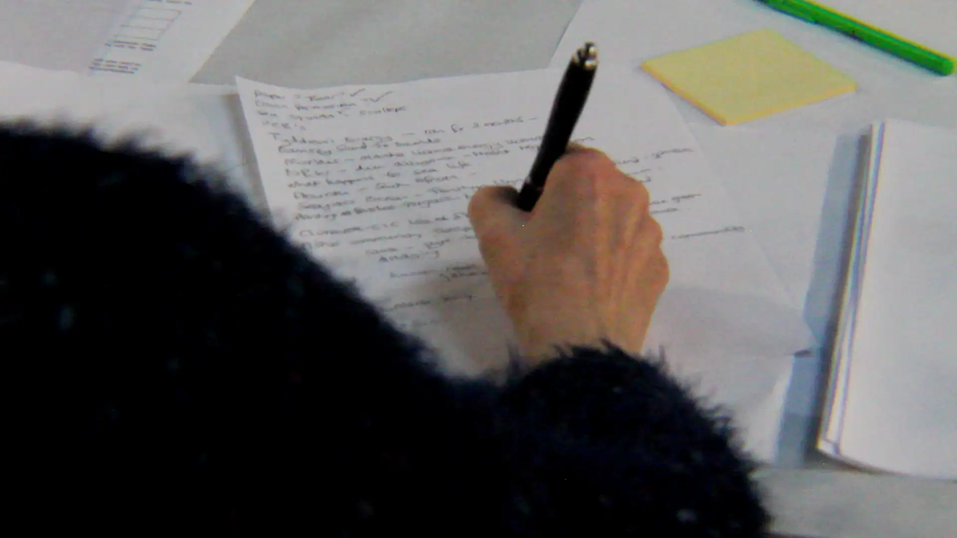 A participant writing notes during a workshop