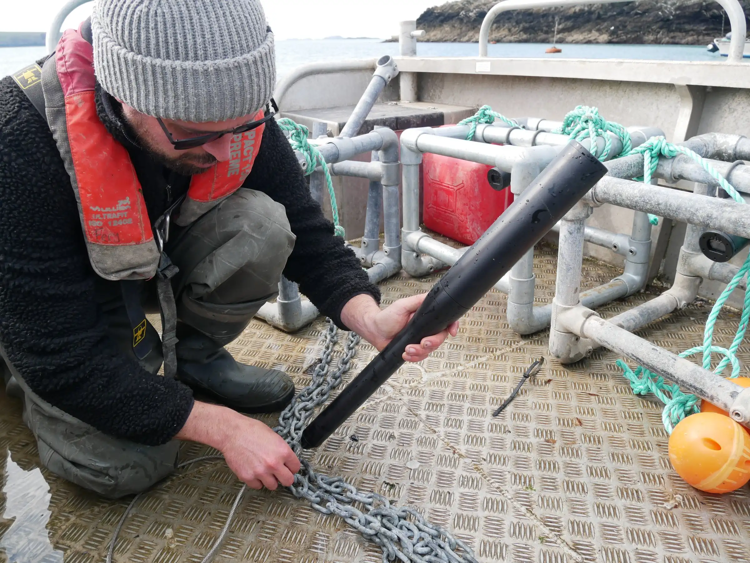 Attaching a GrowProbe 4 to a mooring chain on the deck of a workboat