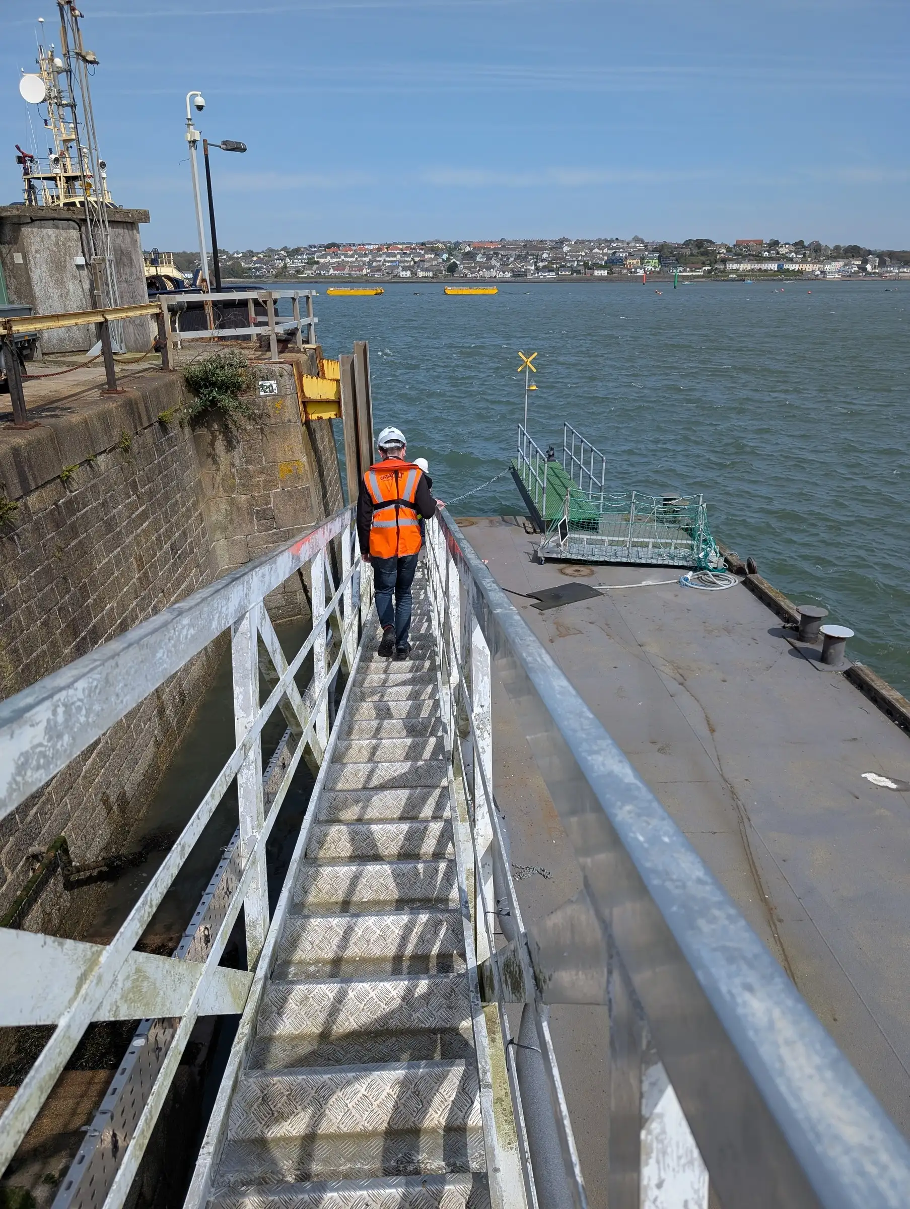 Person walking along a pontoon at the Port of Grimsby