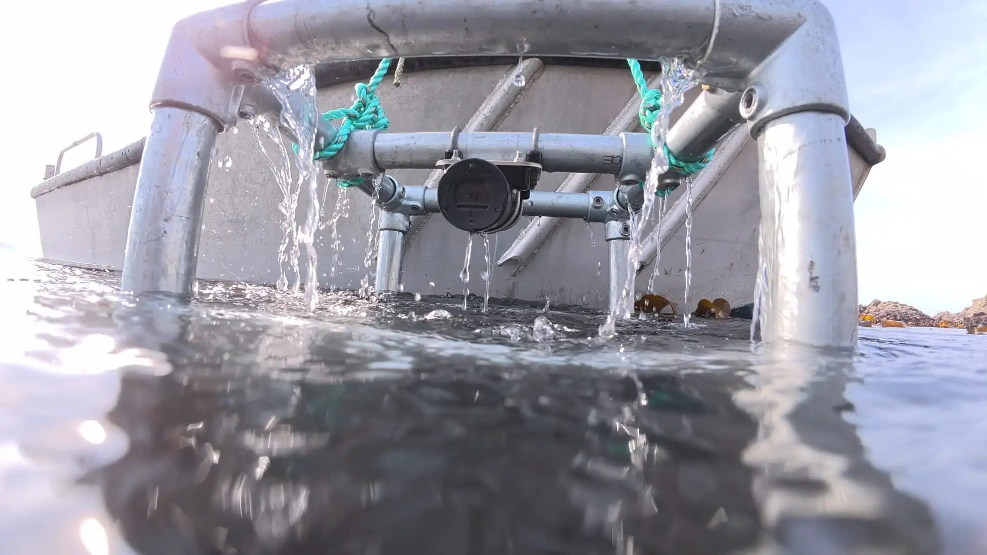 PEBL SubCam monitoring frame being lowered into the sea from a boat